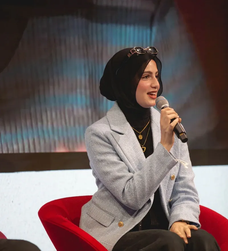 A team member speaking into a microphone on stage