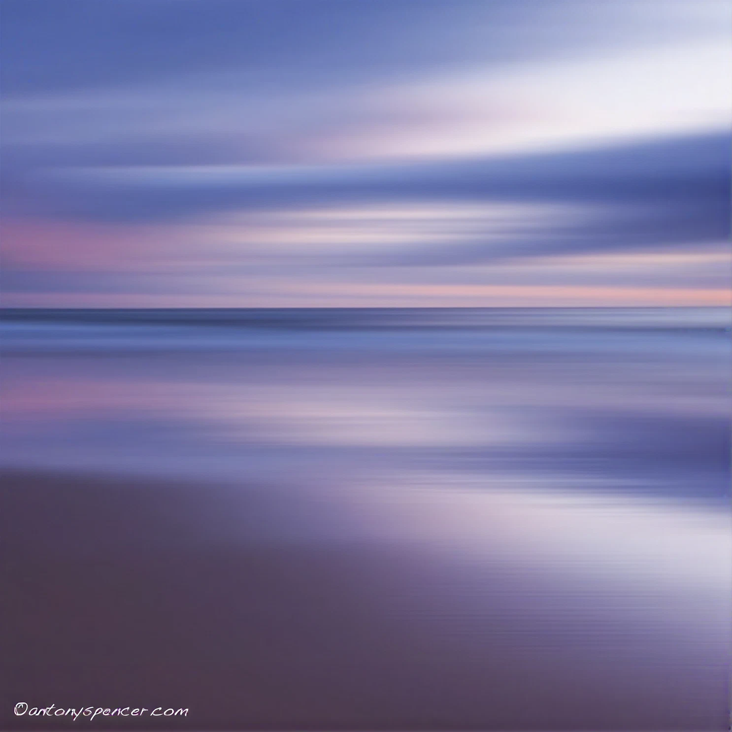 Long-exposure photograph of a sea horizon at dusk